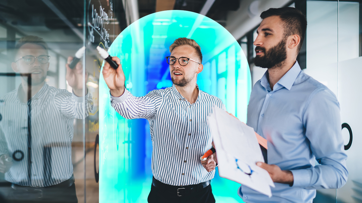 Corporate man pointing at presentation with other corporate man holding paper